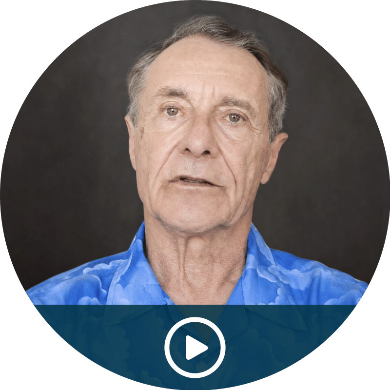 Video thumbnail: portrait of an older man in a blue shirt with a play button overlay, ready to play